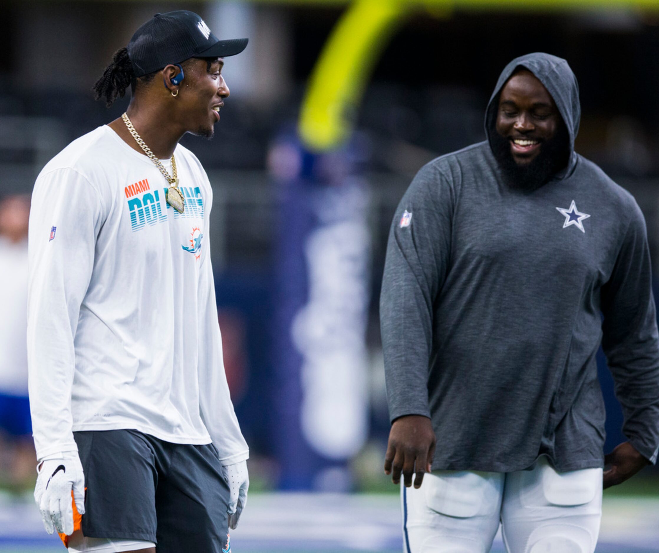 Miami Dolphins defensive end Taco Charlton (96) talks with Dallas Cowboys defensive tackle...