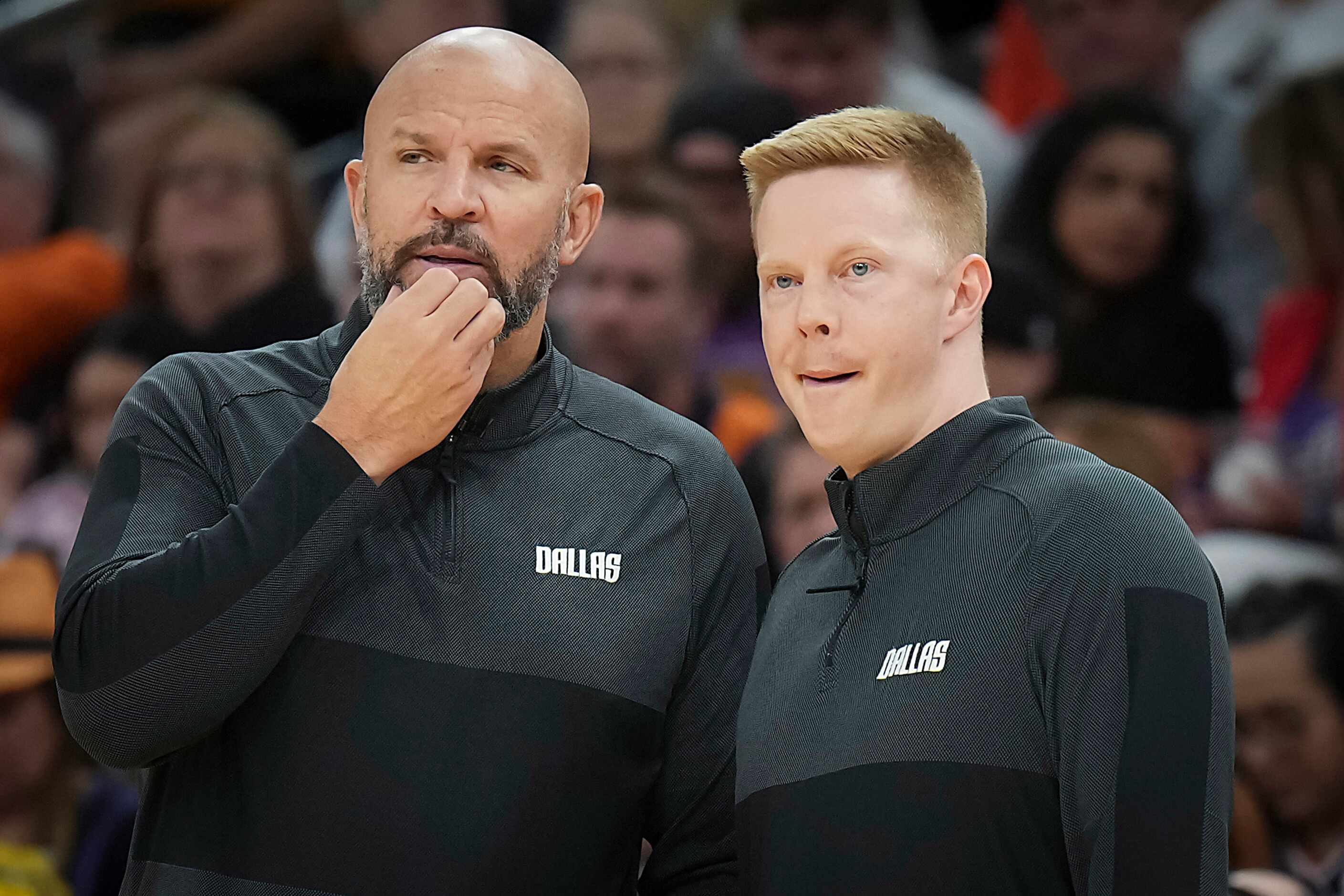 Dallas Mavericks head coach Jason Kidd (left) talks with assistant coach Sean Sweeney during...