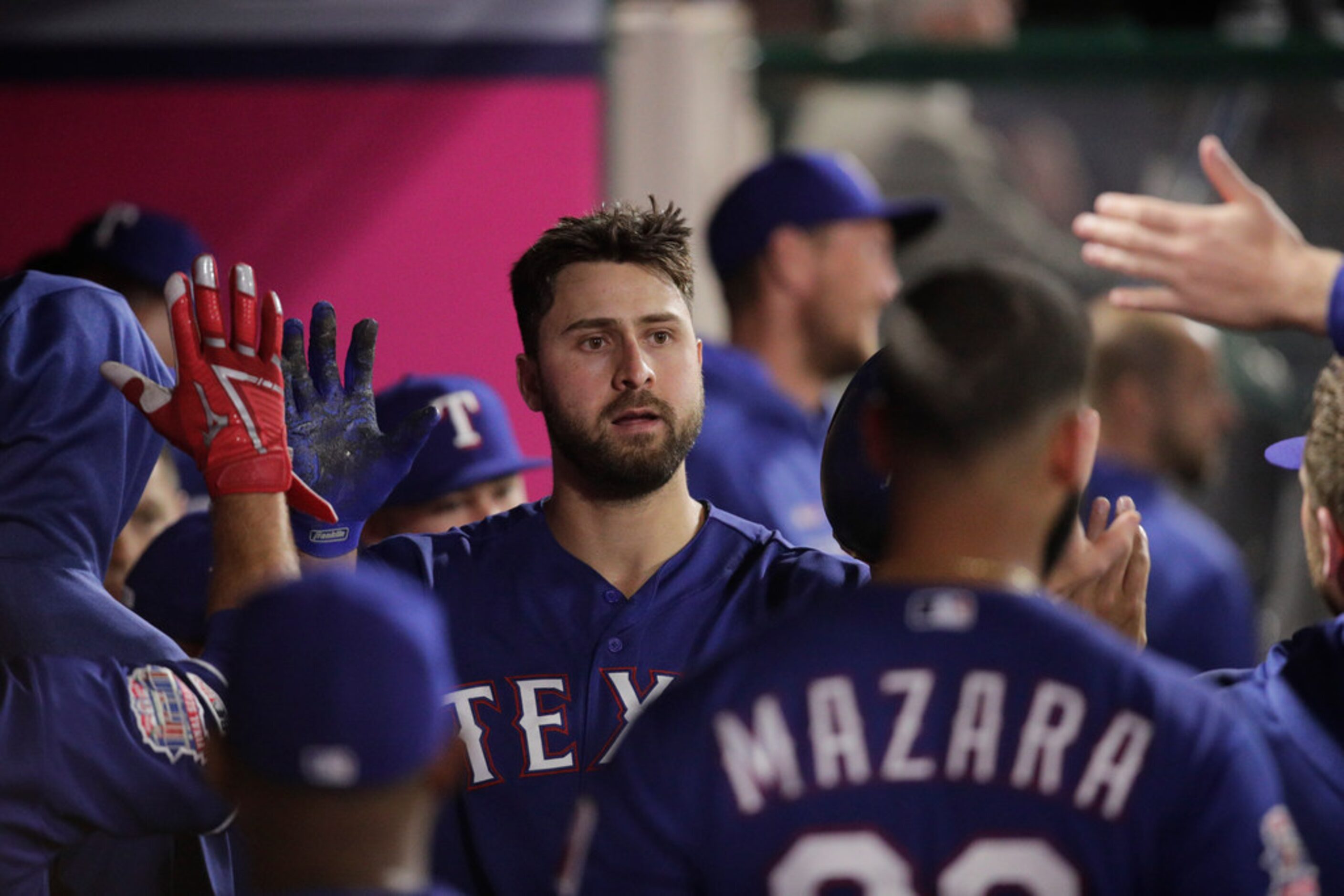 Texas Rangers' Joey Gallo celebrates his home run with teammates during the fourth inning of...