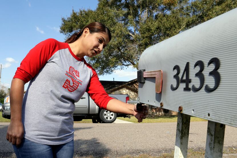 SanJuanita Garza checks the mailbox at her home in Pearland, TX, Nov. 22, 1017, for checks...