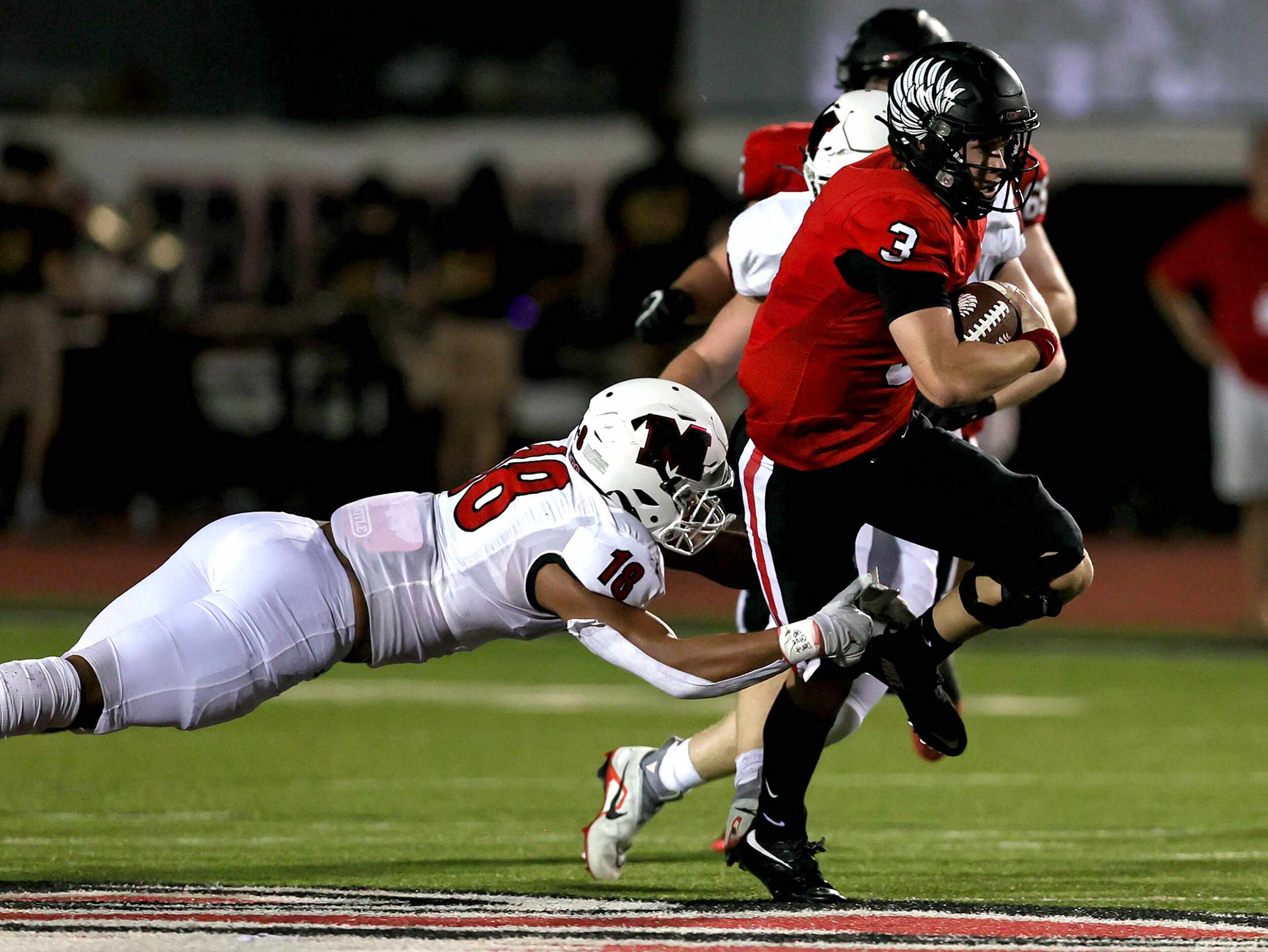 Argyle quarterback Jacob Robinson finds a hole and tries to get past Melissa's Caleb...