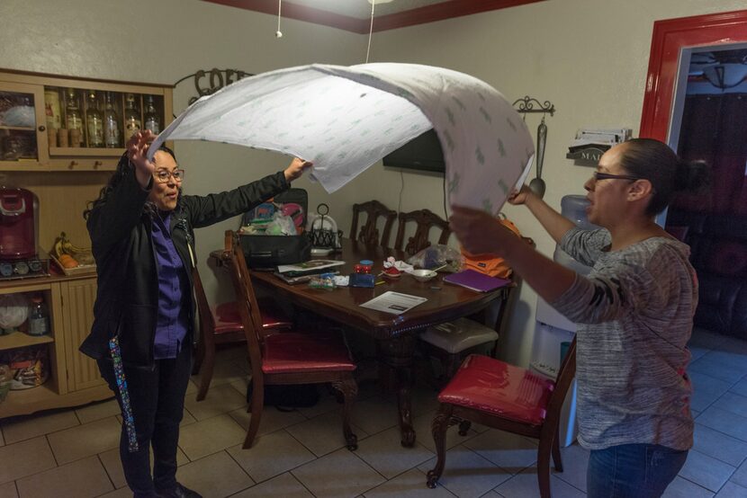 Evelyn Vasquez-Argueta (left), a home instructor with Irving ISD, goes over curriculum...