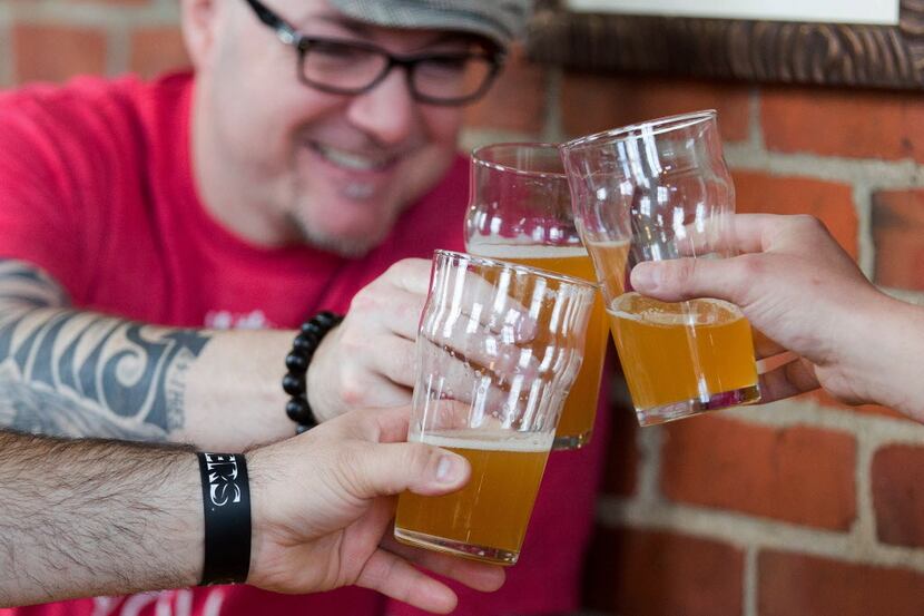 Matt Bradley, of Kalamazoo, cheers with his friends at Bell's Eccentric Cafe during Oberon...