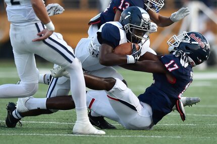 FILE - Ryan senior DB Rondarius McGarr (17) brings down Wylie East junior RB Corbin Johnson...