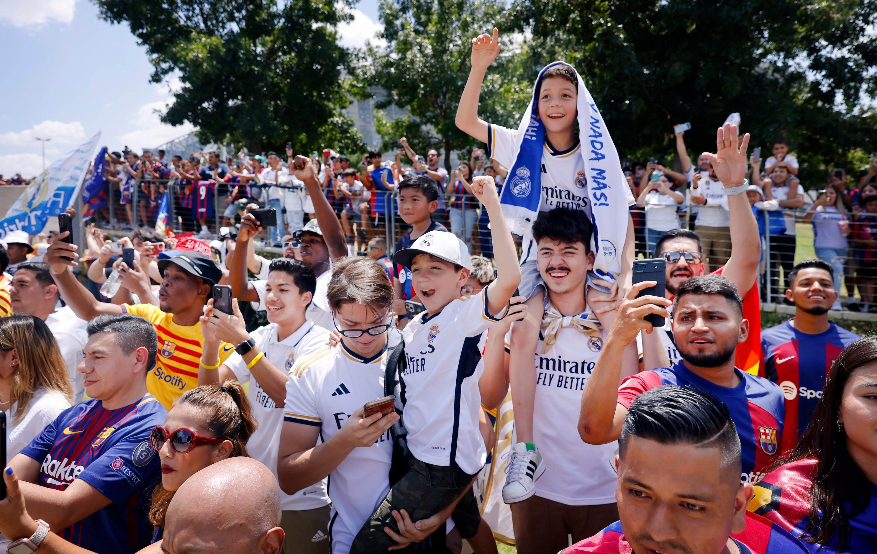 Real Madrid soccer fans cheer as their team buses arrive for their Soccer Champions Tour...