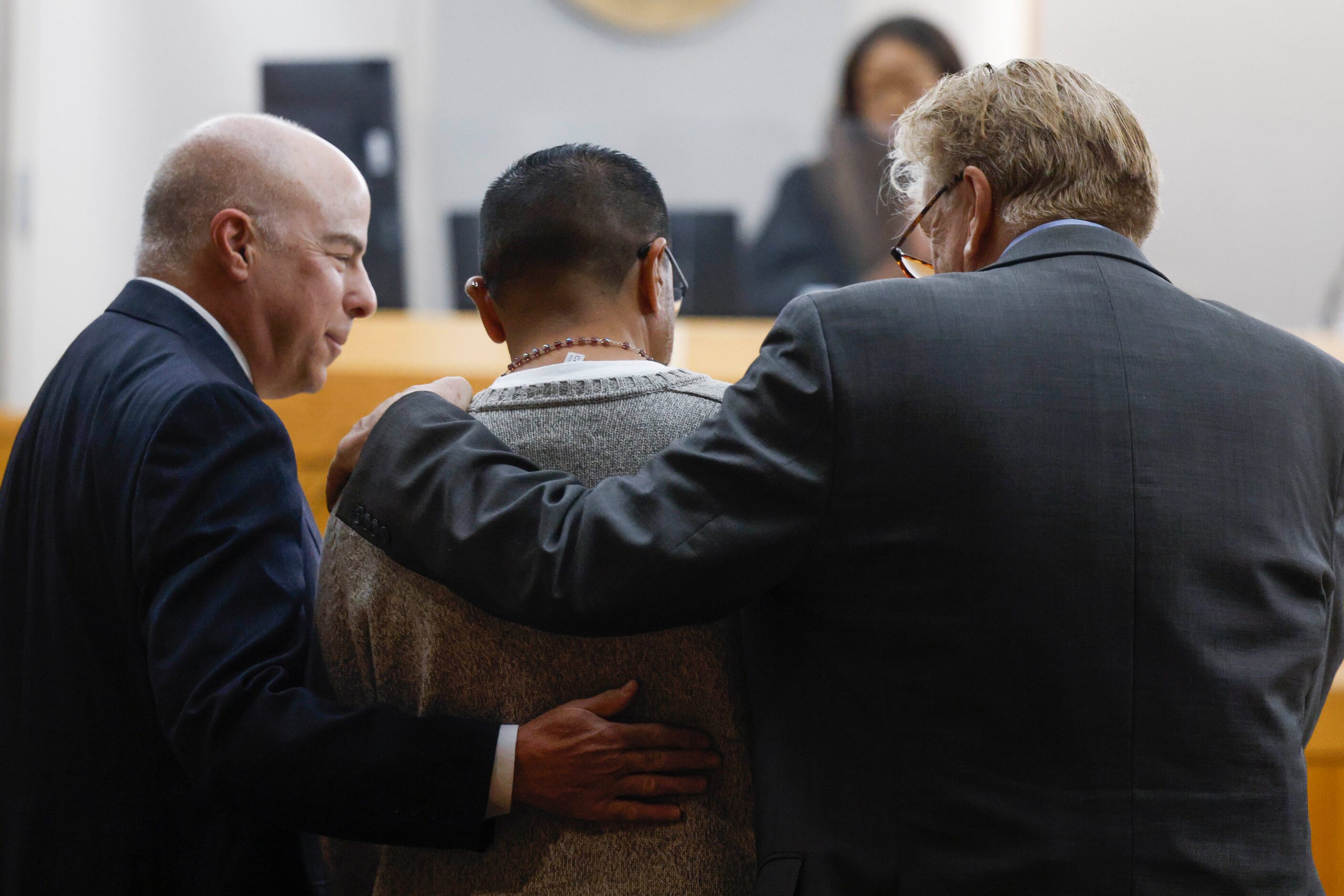 Defense lawyers Gary Udashen (left), and Paul Casteleiro (right), hug Martin Santillan at...