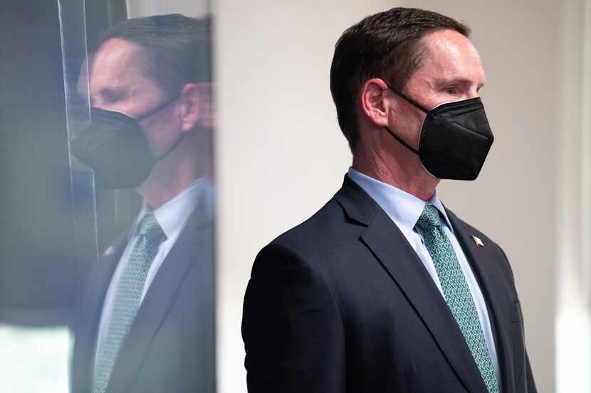 Dallas County Judge Clay Jenkins wears a make as he waits to speak during a press conference...