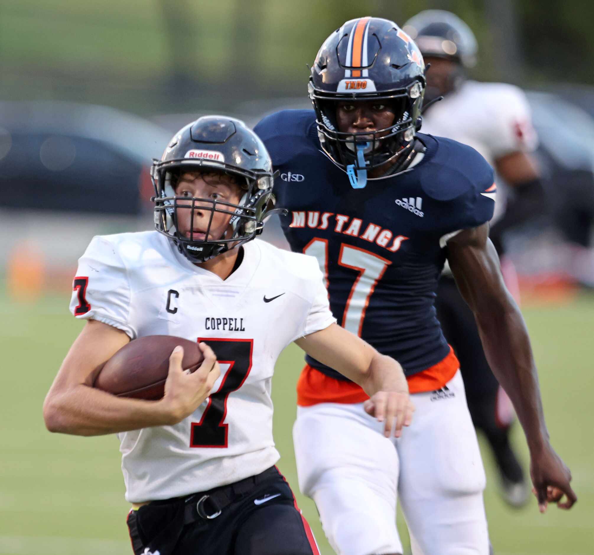 Coppell QB Jack Fishpaw (7) runs for a first down, as he is chased by Sachse defender Cheta...