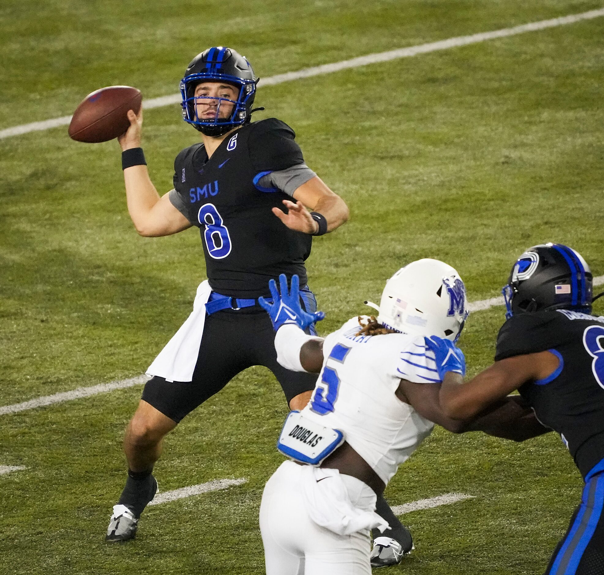 SMU quarterback Tanner Mordecai (8) throws a pass as quarterback Tanner Mordecai (8) blocks...