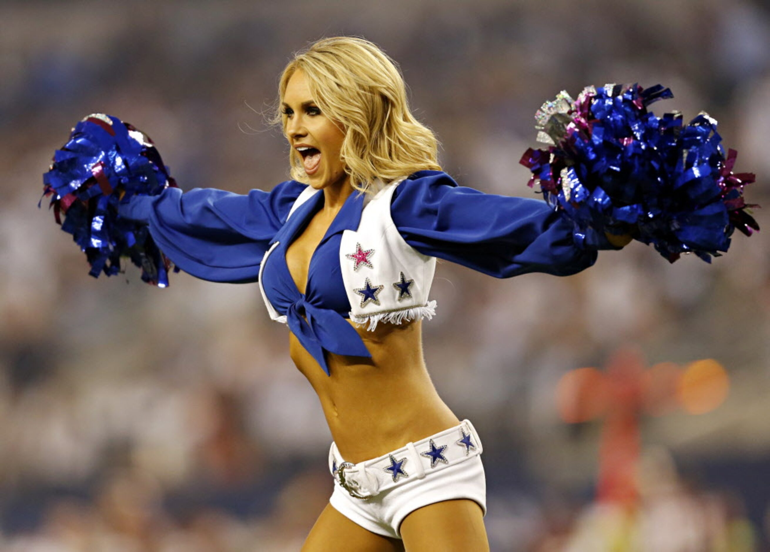 A Dallas Cowboys cheerleader performs during the first half against the Washington Redskins...