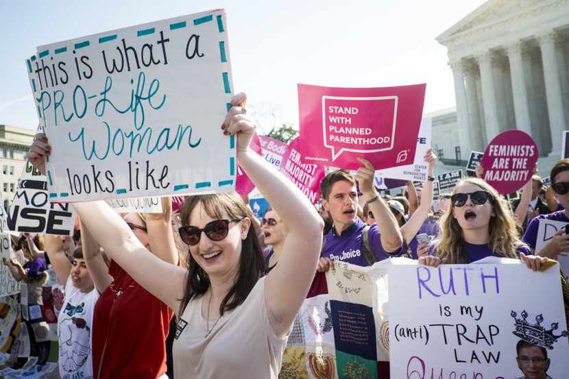 Abortion activists demonstrate on the steps of the United States Supreme Court on June 27,...