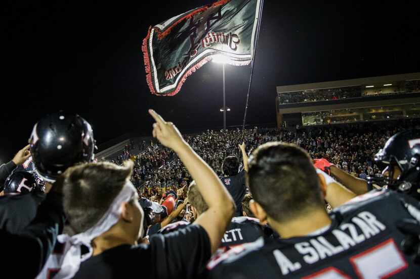 Euless Trinity celebrates a 37-35 win over Southlake Carroll after their game on Friday,...