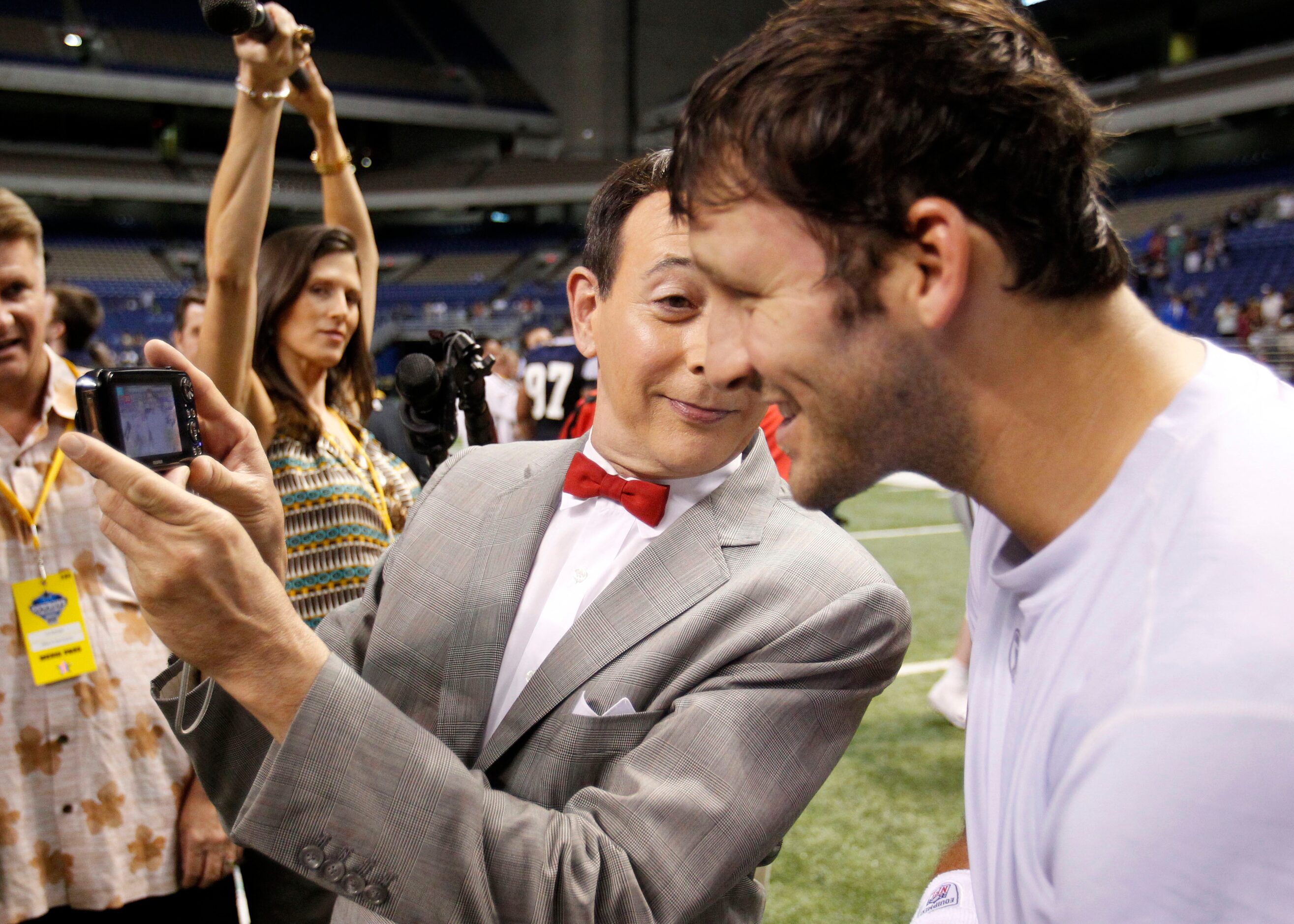 Entertainer Pee-wee Herman (Paul Reubens) shows Dallas Cowboys Tony Romo the picture they...