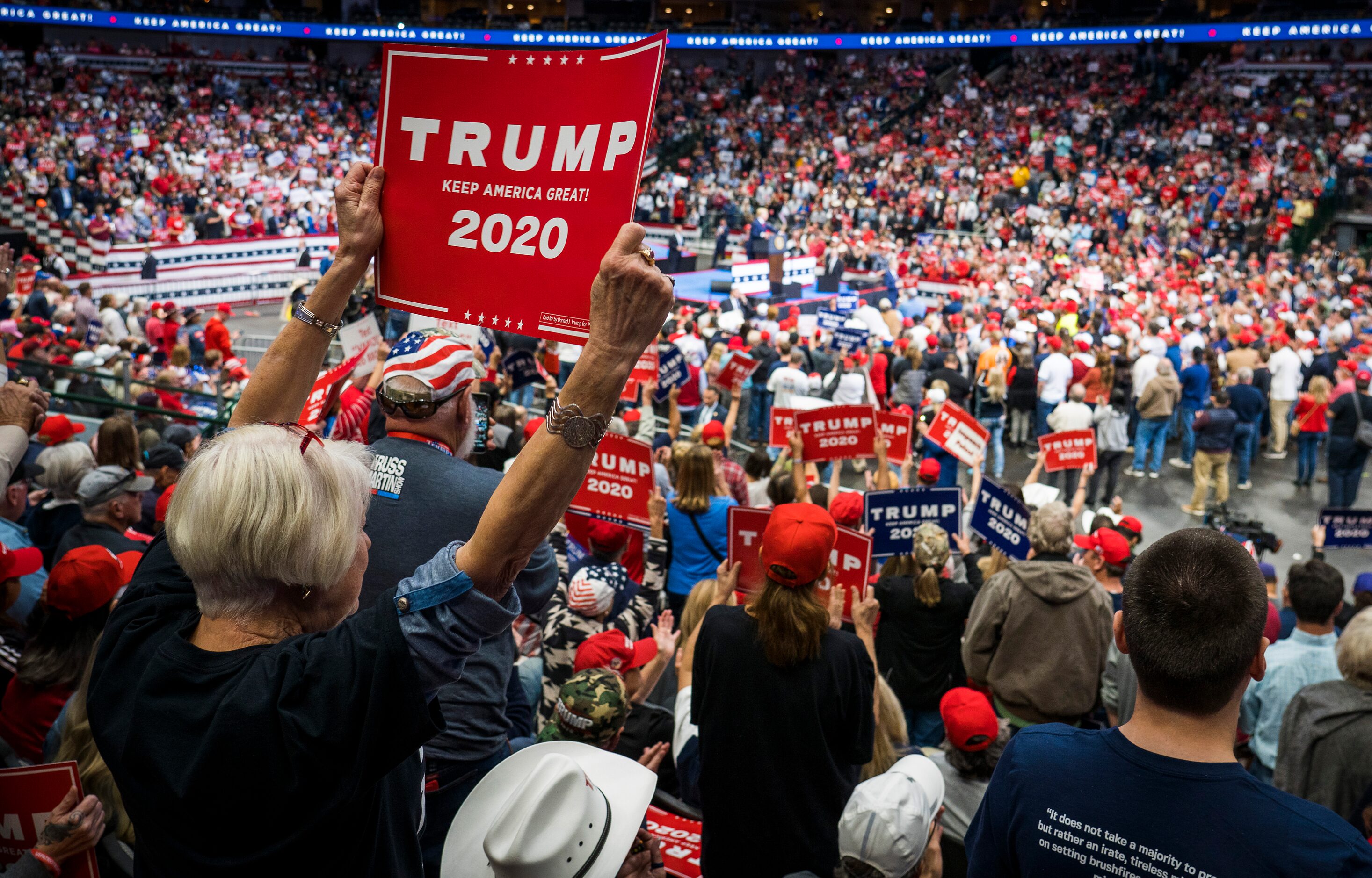 Supporters cheer President Donald Trump as he addresses a campaign rally at the American...