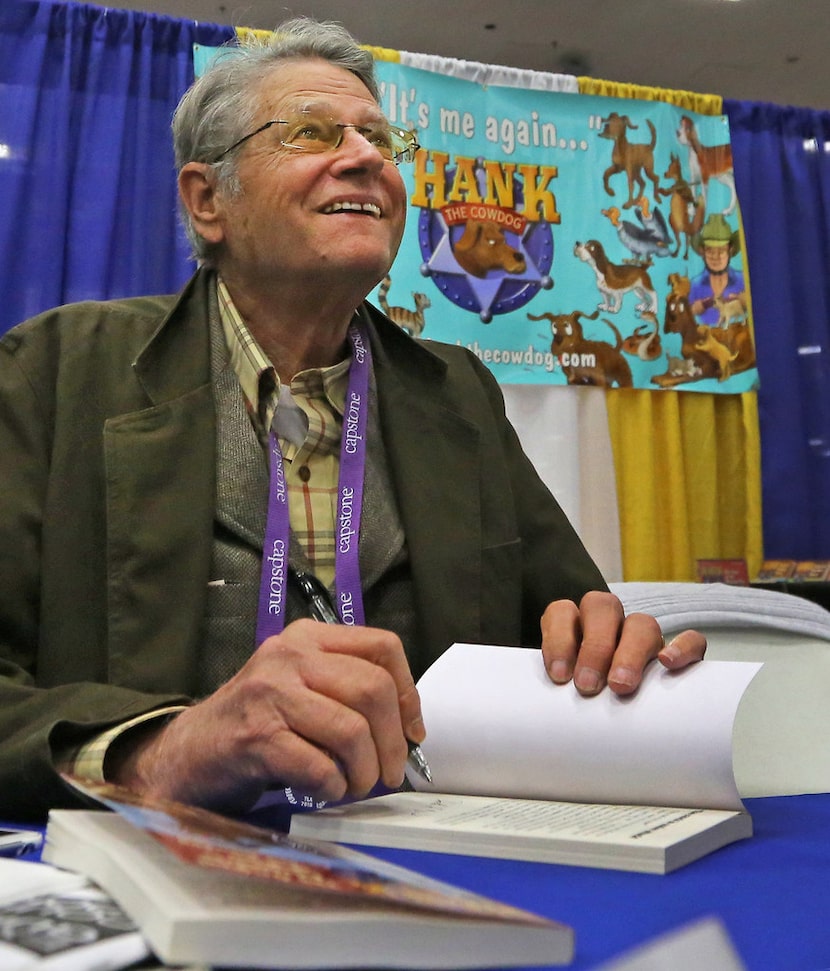 John Erickson, author of the Hank the Cowdog books, signs books at the Texas Library...