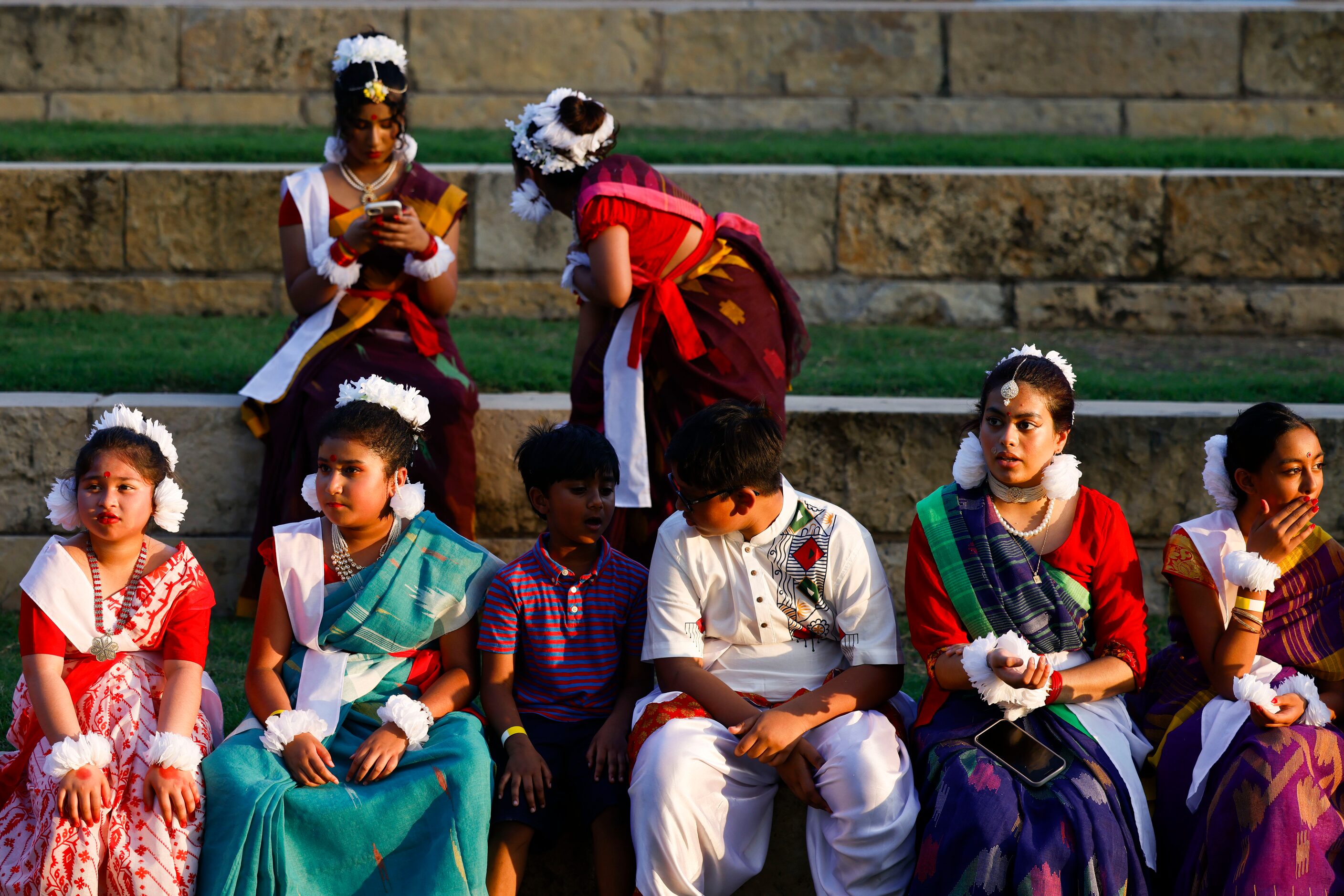 Young performers dressed with traditional Bangladeshi attire remain on the pavilion ahead of...