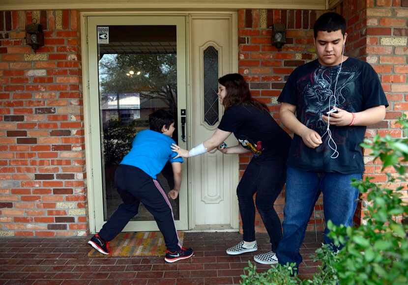 
Emily Thompson, 12, fights off her brother, Strother,  while Arturo (right) looks on...