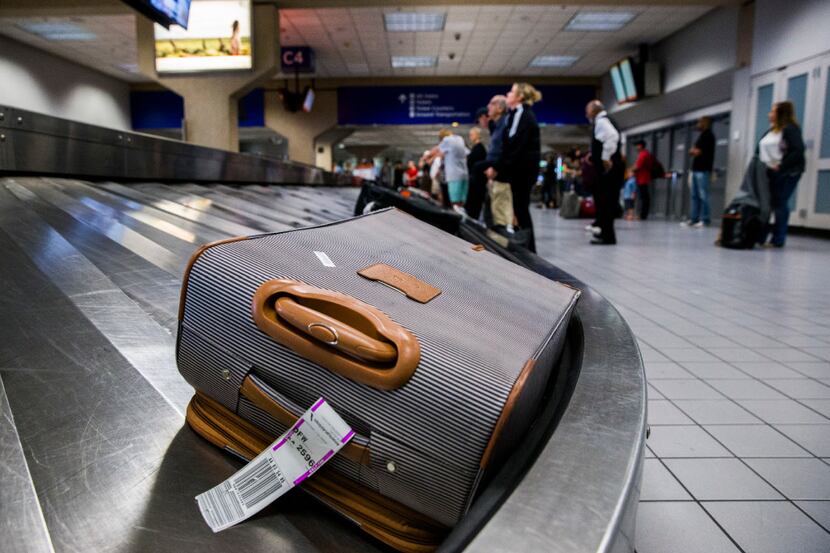 Luggage circles a baggage claim at Gate C on Friday, March 10, 2017 at DFW international...