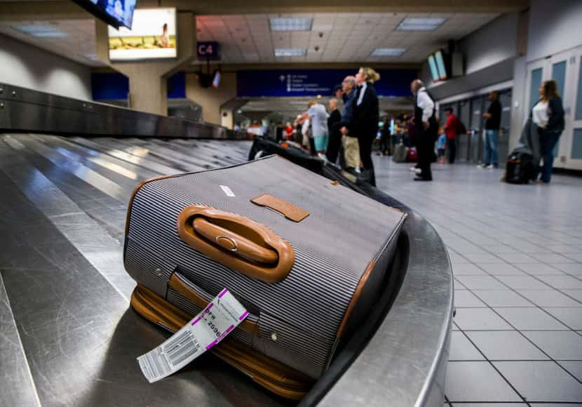 Luggage circles a baggage claim at Gate C on Friday, March 10, 2017 at DFW international...