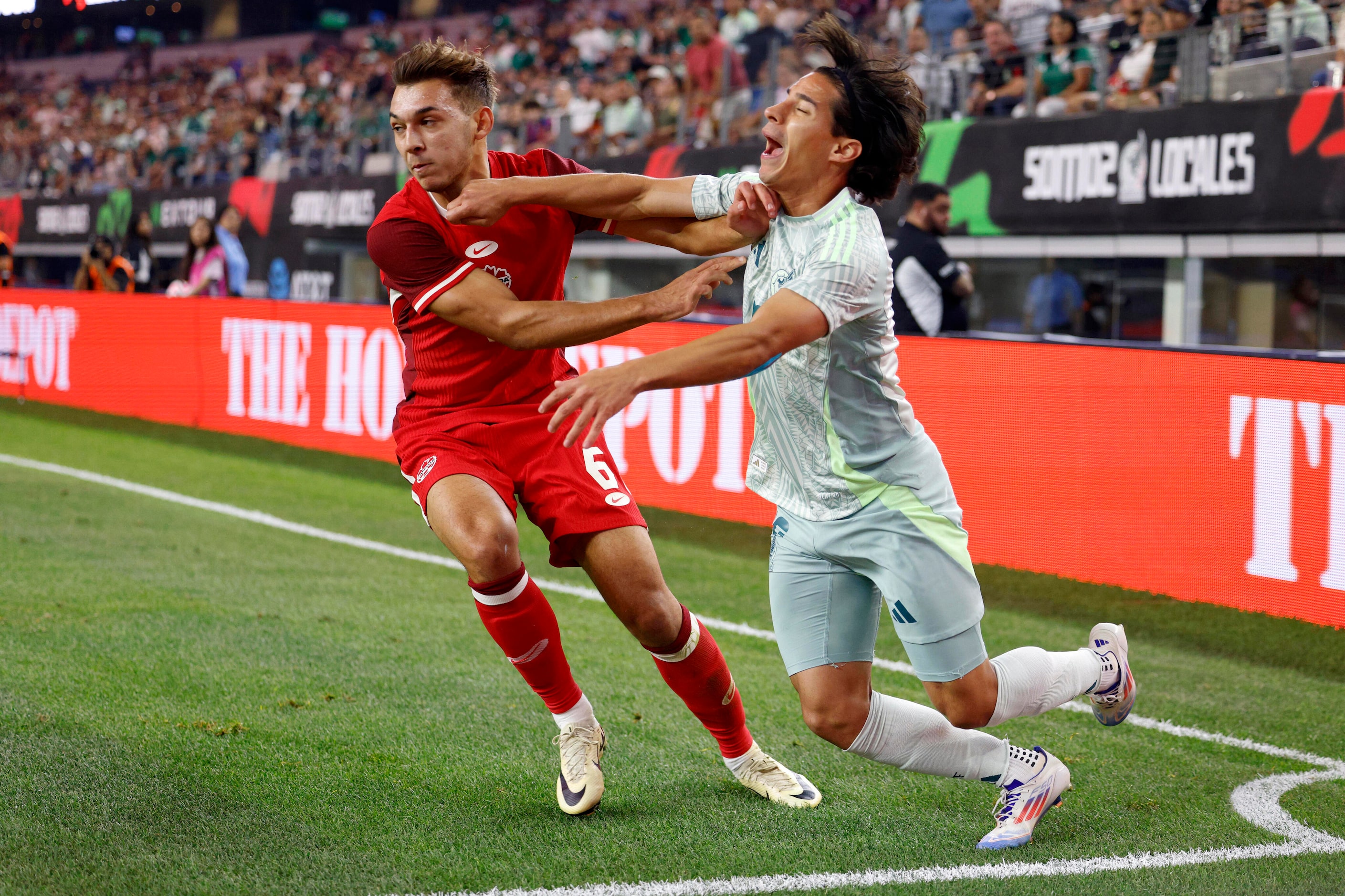 Mexico midfielder Diego Lainez (16) reacts after being fouled by Canada midfielder Niko...