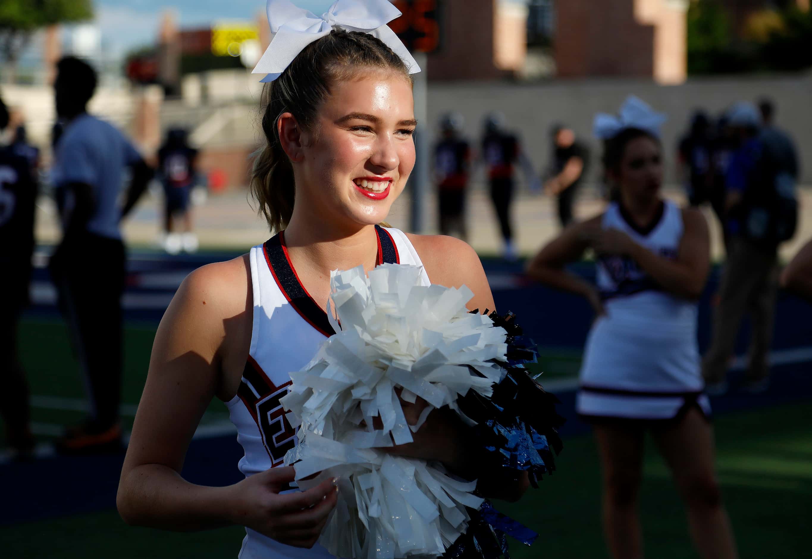 Allen High School varsity cheerleader Brooke Baker, 17, gets ready for kickoff as Allen High...