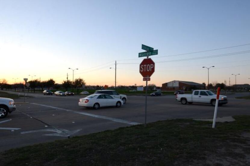 
Cars make their way through a four-way stop at the intersection of Ohio Drive and Warren...