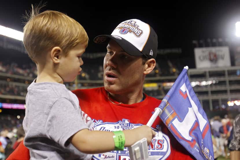 Texas Rangers Colby Lewis (48) with his son Cade, 3 after defeating the New York Yankees in...