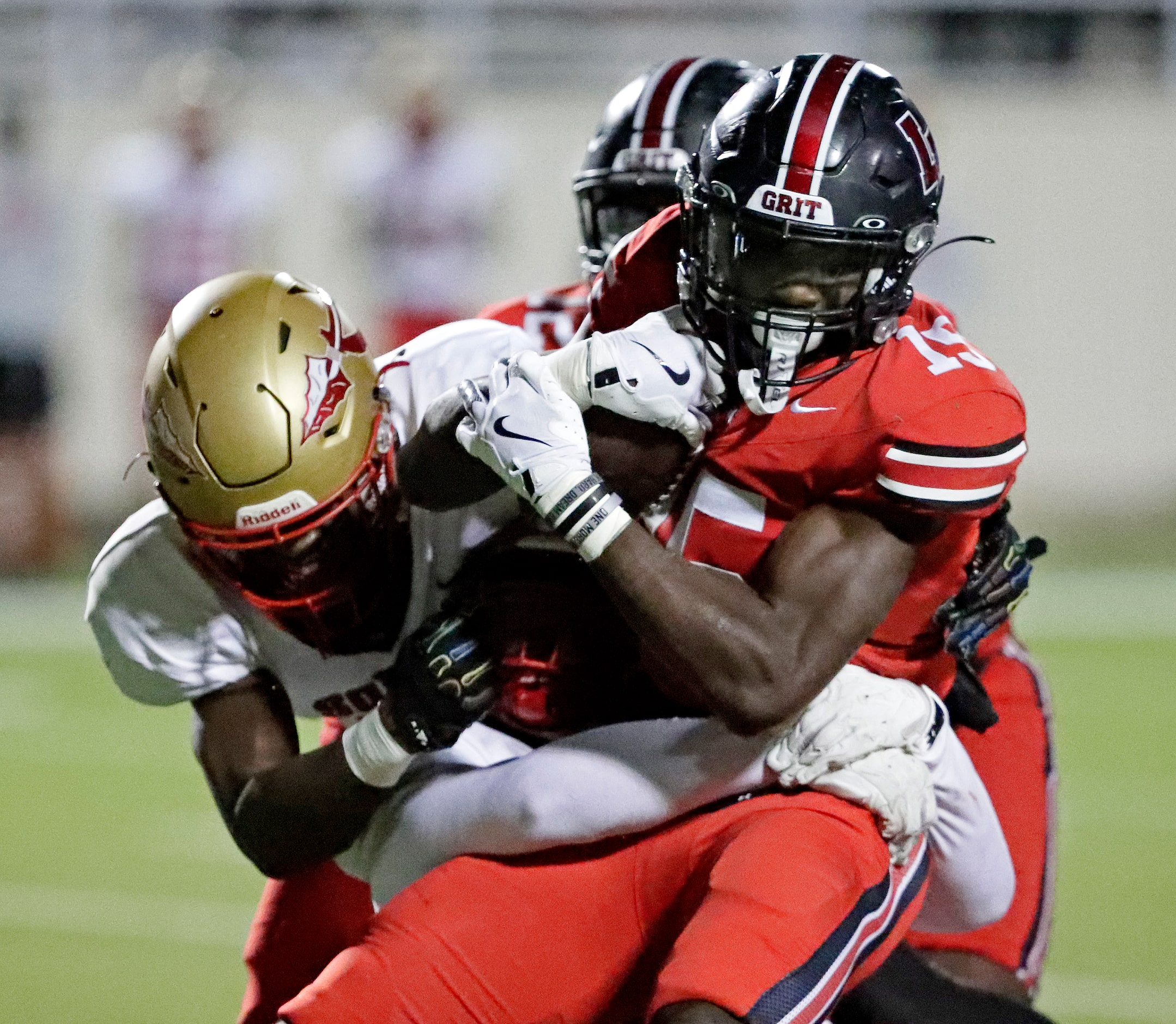 Lake Highlands High School running back Christian Rhodes (15) is tackled by South Grand...