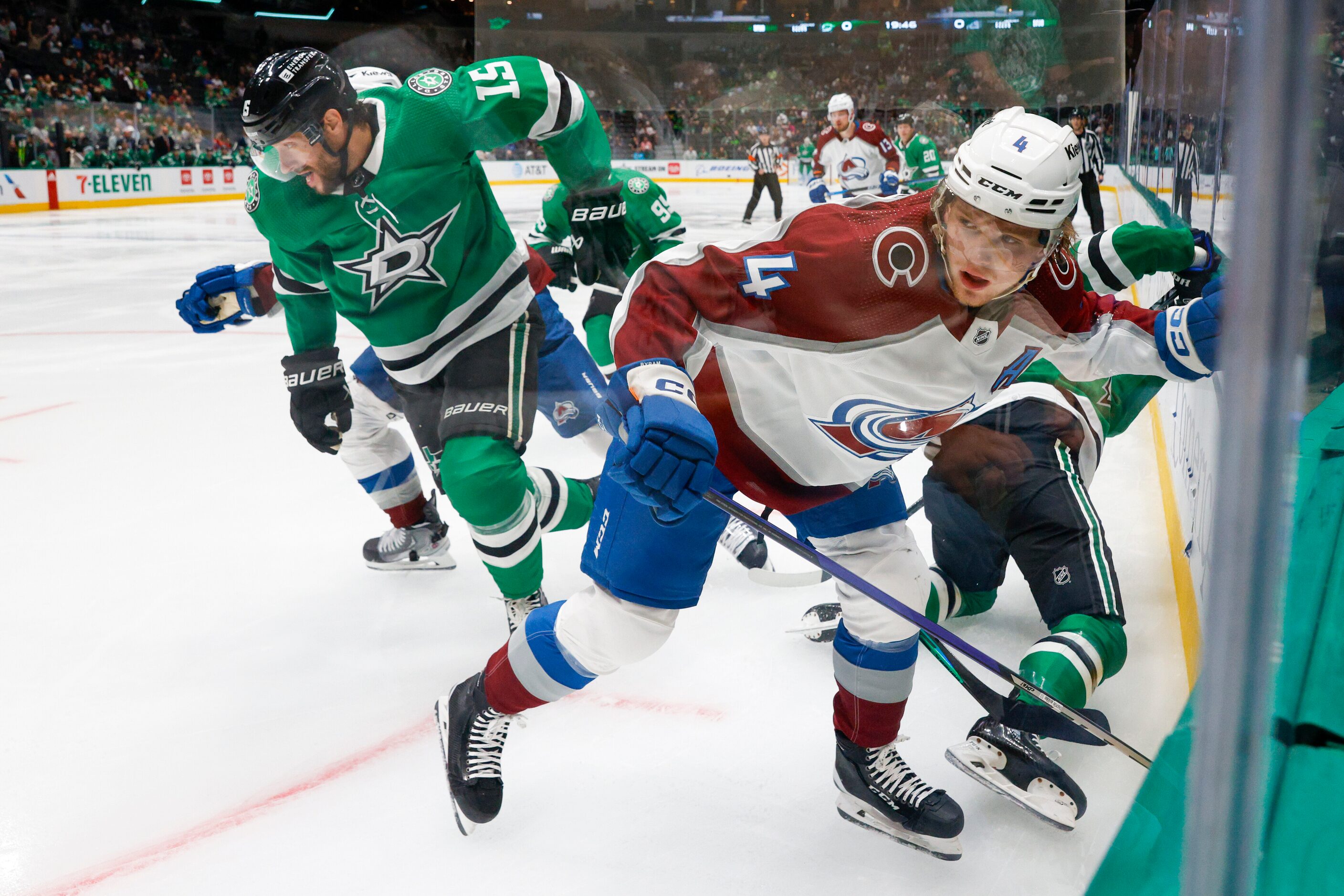 Dallas Stars center Craig Smith (15) and Colorado Avalanche defenseman Bowen Byram (4) skate...