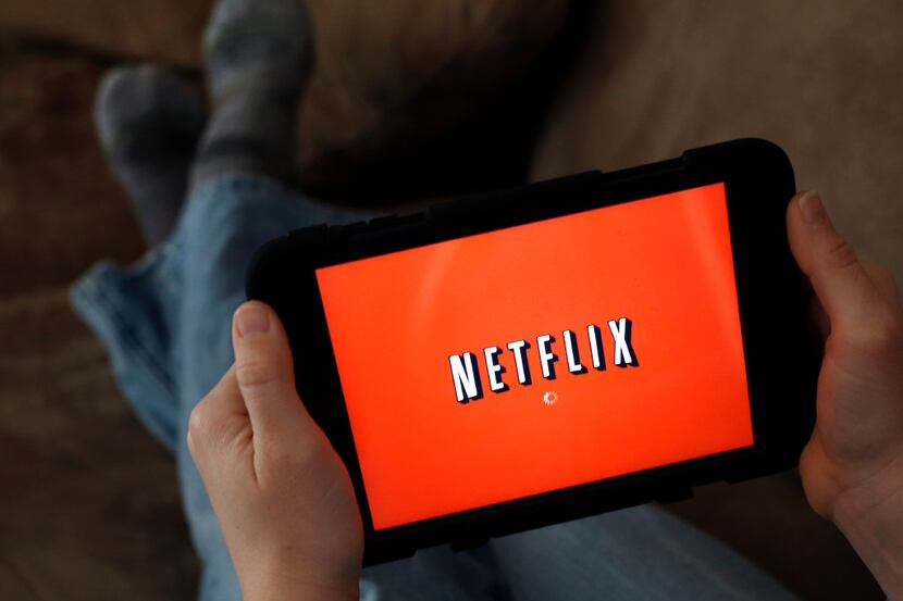 FILE - In this Friday, Jan. 17, 2014, file photo, a person displays Netflix on a tablet in...