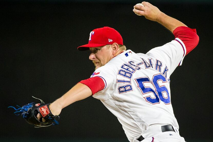 Texas Rangers pitcher Austin Bibens-Dirkx pitches during the ninth inning of a 9-3 victory...