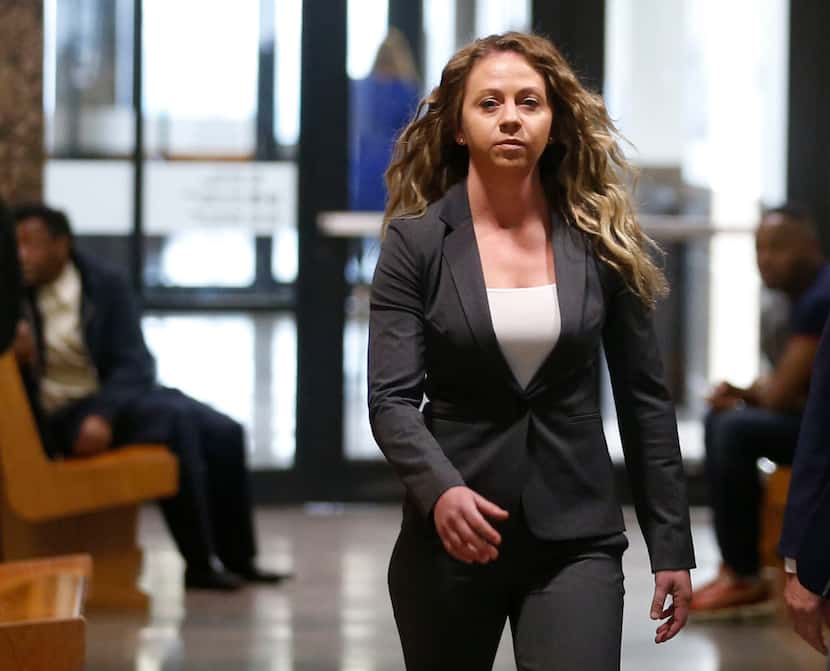 Former Dallas police Officer Amber Guyger (left) walked the hallway after court date at the...