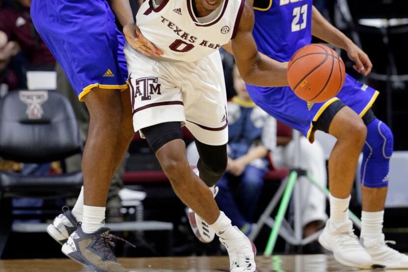 Texas A&M guard Jay Jay Chandler (0) drives between UC Santa Barbara forward Leland King II...