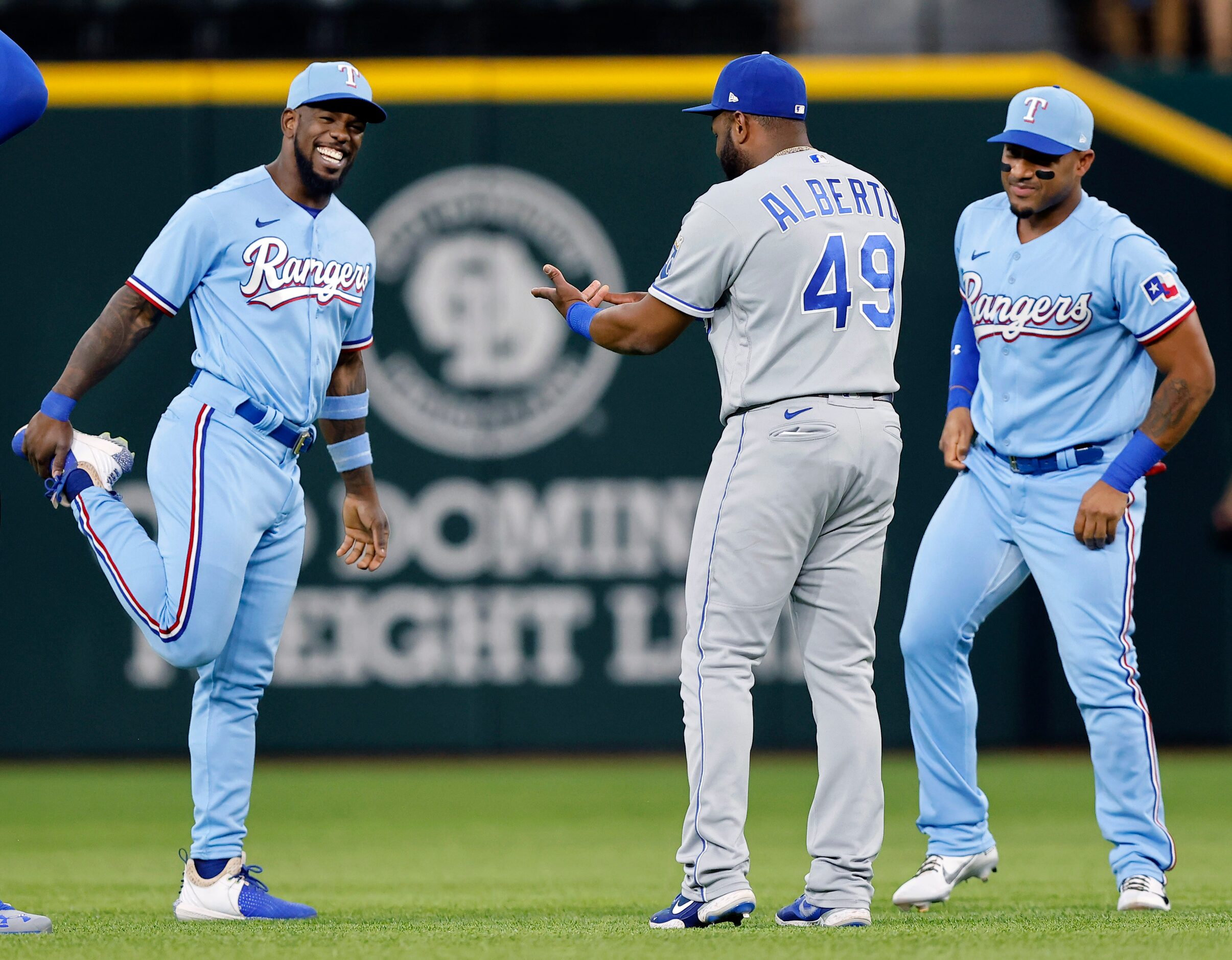 Texas Rangers Adolis Garcia (left) and Andy Ibanez (right) visit with Kansas City Royals...