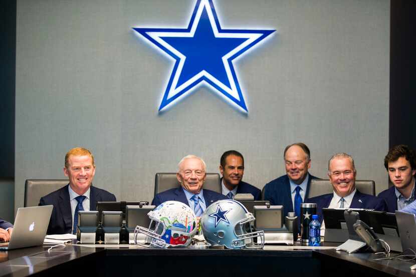 FILE - Dallas Cowboys Owner Jerry Jones, center, Head Coach Jason Garrett, left, CEO and...