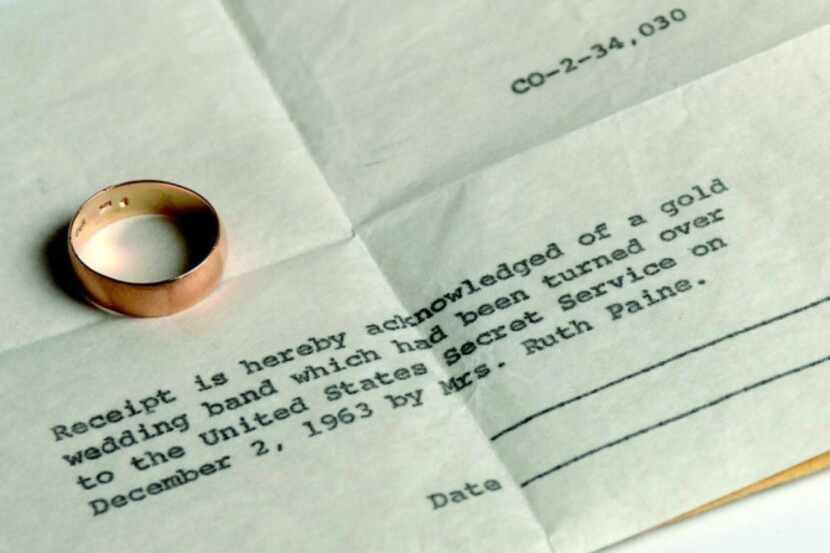 Lee Harvey Oswald's gold wedding band is seen next to the Secret Service receipt for the...