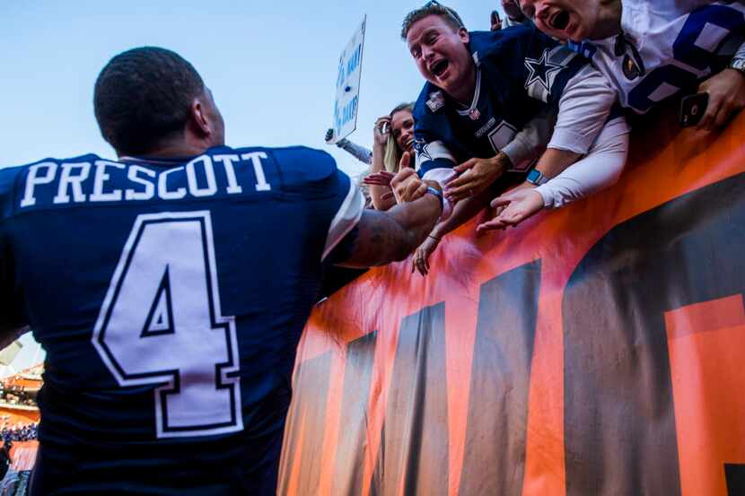 Dallas Cowboys quarterback Dak Prescott (4) celebrates with fans after the Cowboys won 35-10...