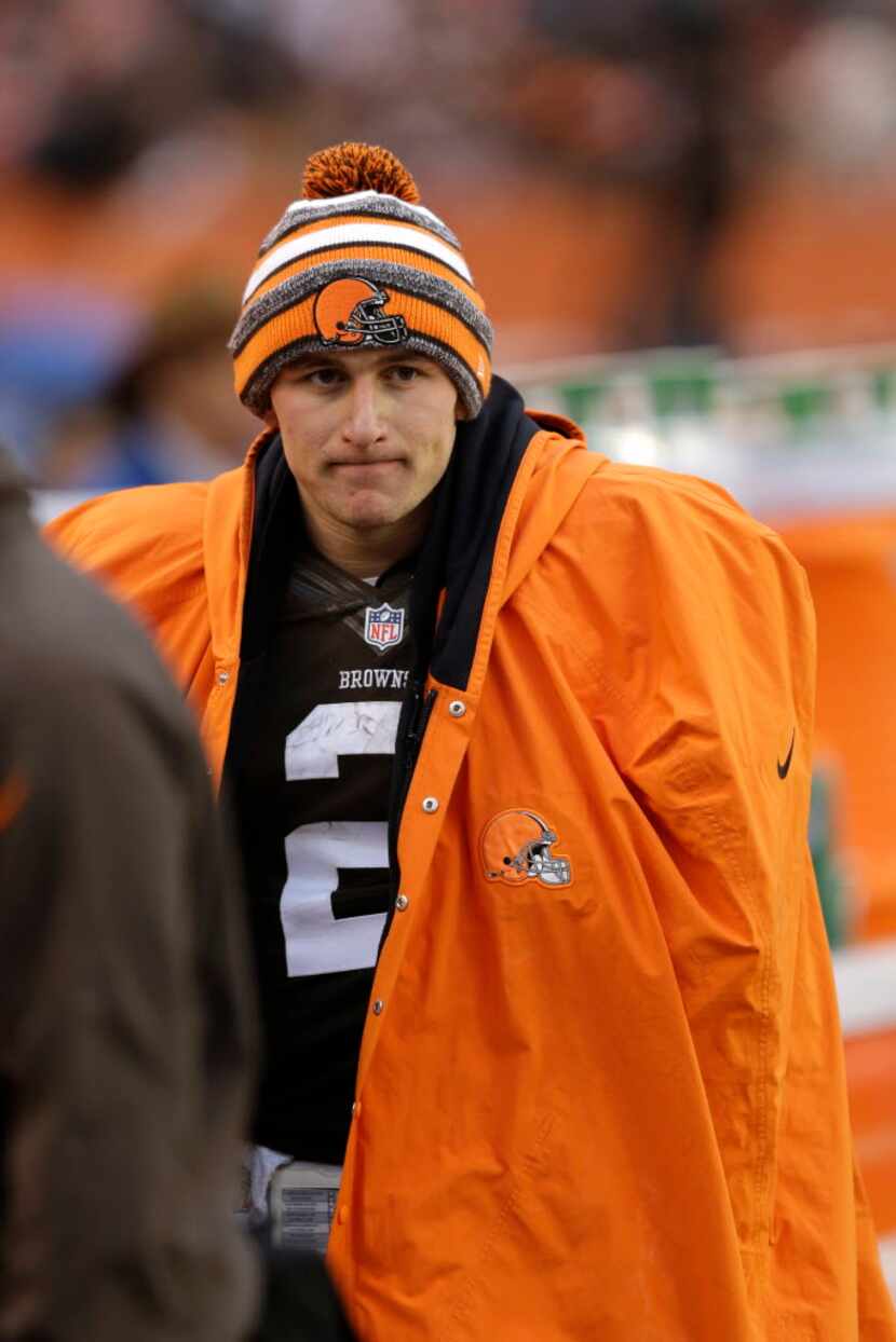 FILE - In this Dec. 14, 2014 file photo, Cleveland Browns quarterback Johnny Manziel watches...