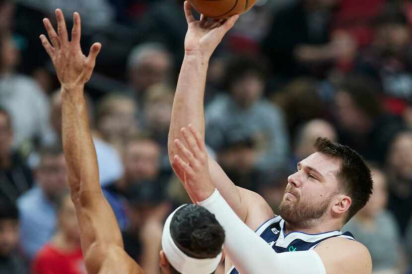 Dallas Mavericks guard Luka Doncic shoots over Portland Trail Blazers guard Josh Hart during...