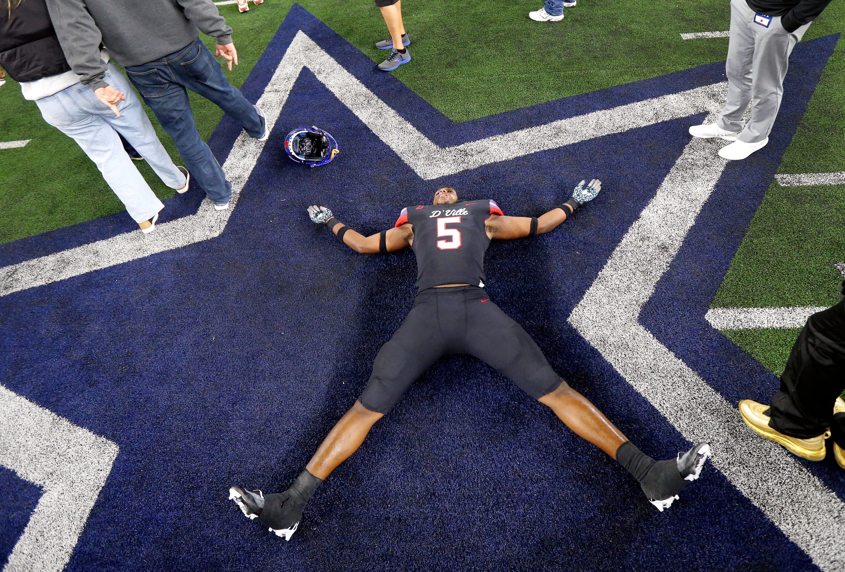 Duncanville linebacker Elijah Wilson (5) collapsed on the Cowboys Star and did snow angels...