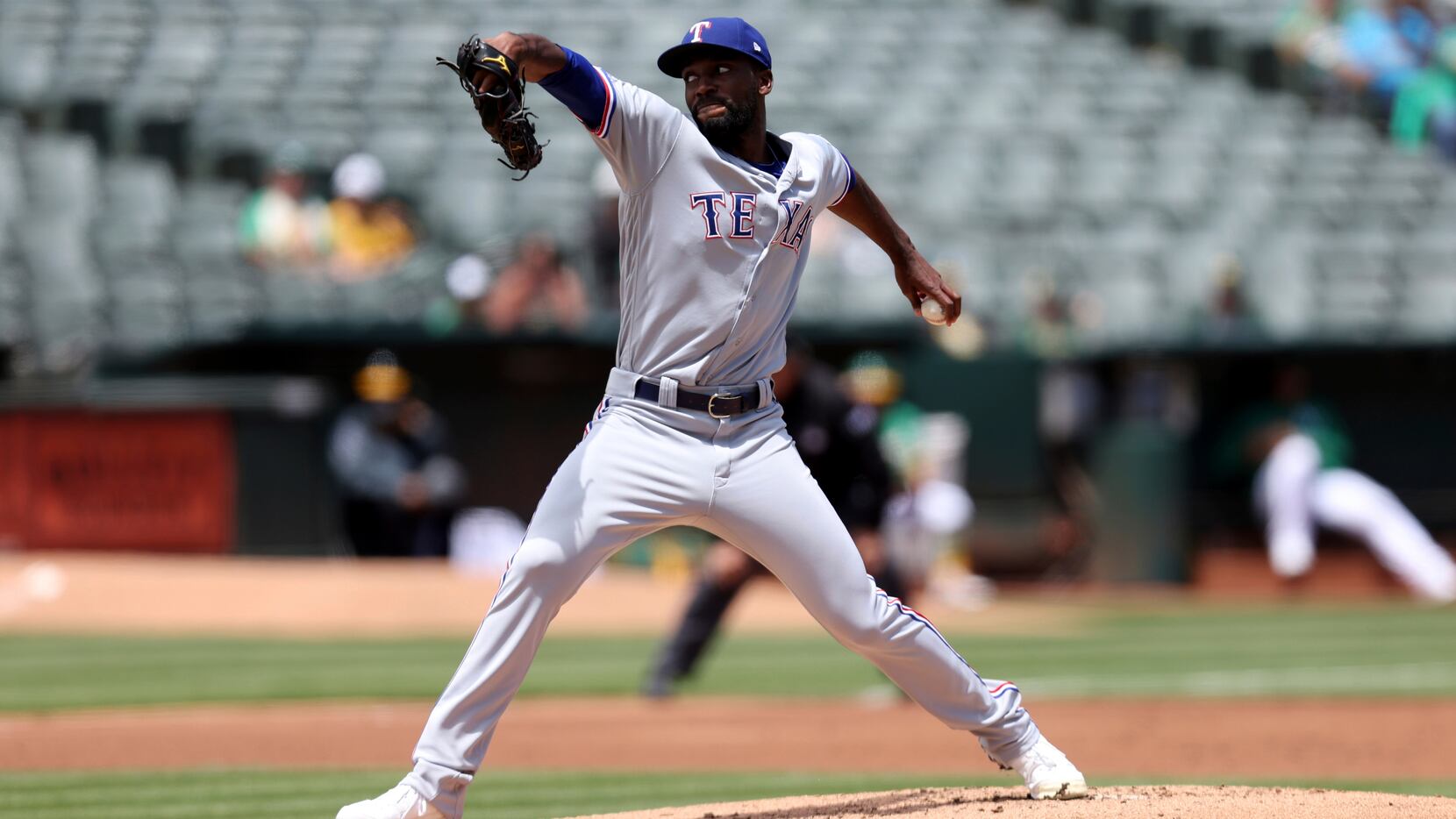 Texas Rangers' Taylor Hearn pitches against the Oakland Athletics during the first inning of...