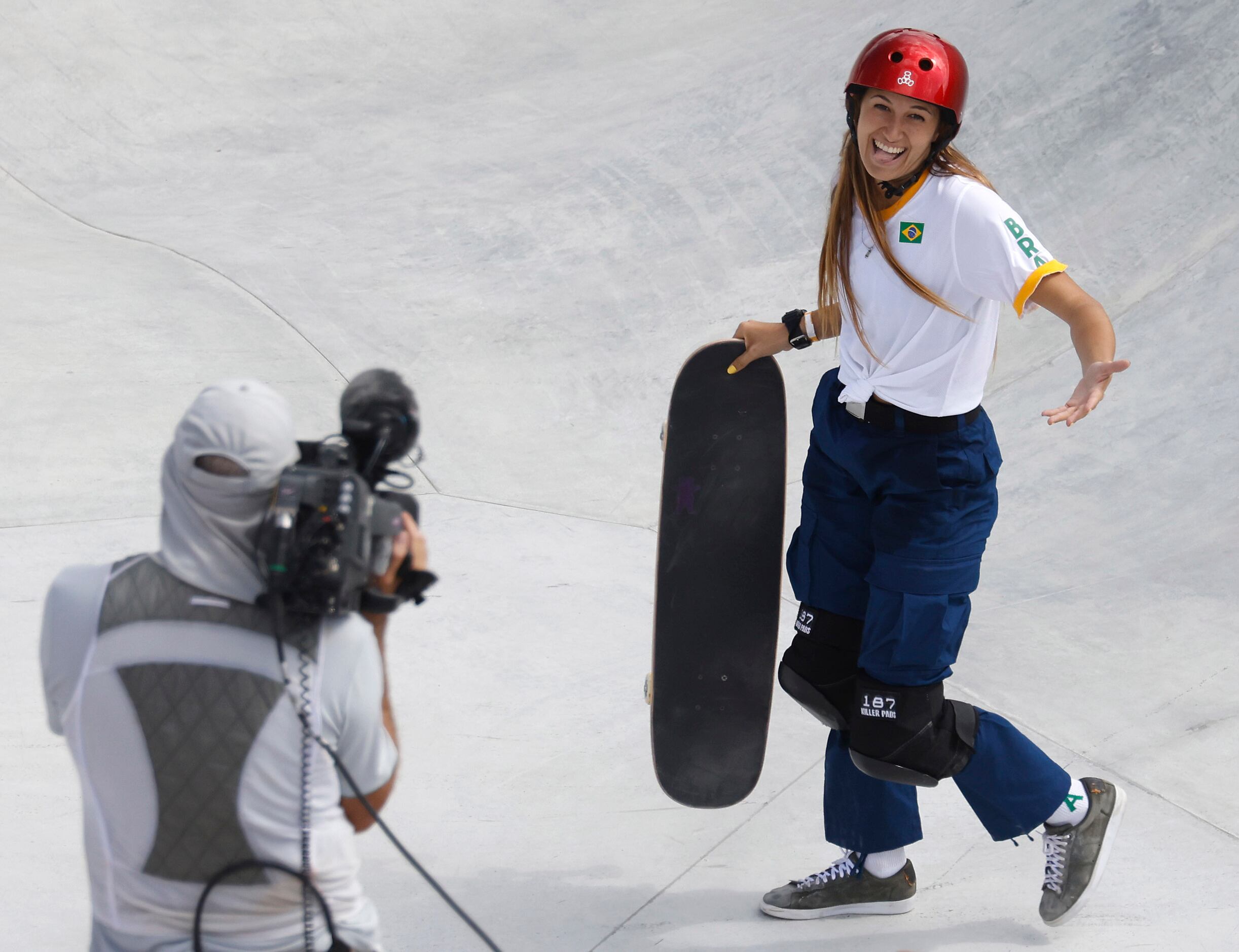 Brazil’s Dora Varella reacts towards the camera after a run during the women’s skateboarding...