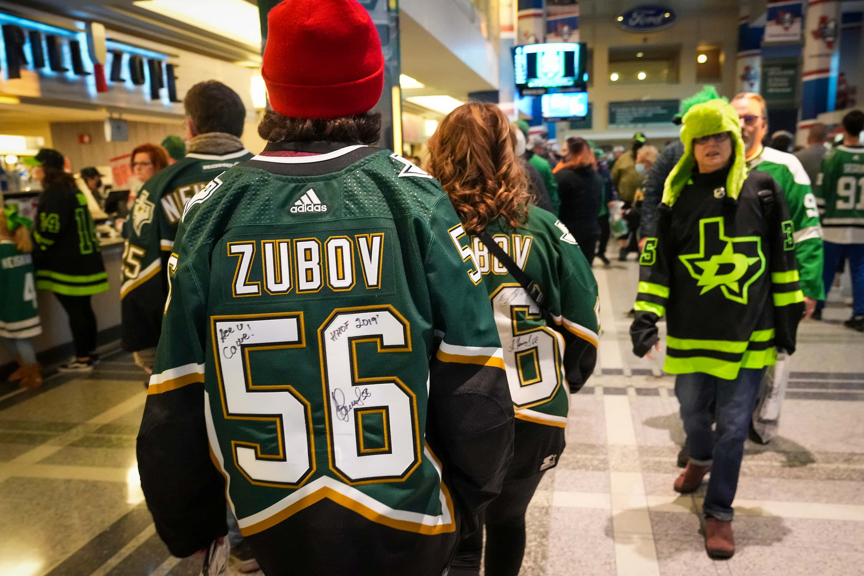 Fans wear the jersey of former Dallas Stars player Sergei Zubov as they arrive for his...