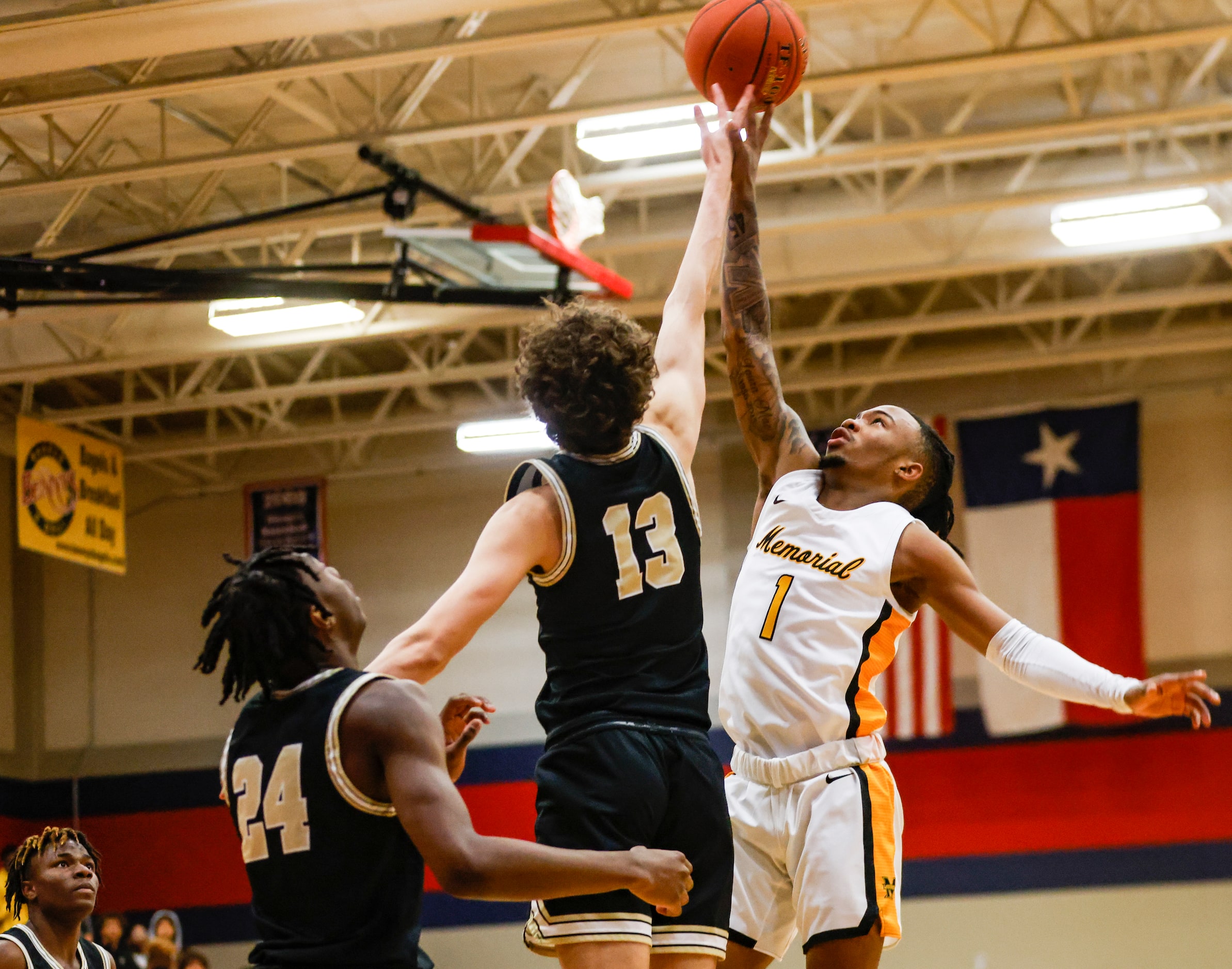 The Colony High School Grayson Ryan (13) and Memorial High School Isaiah Foster (1) jump to...