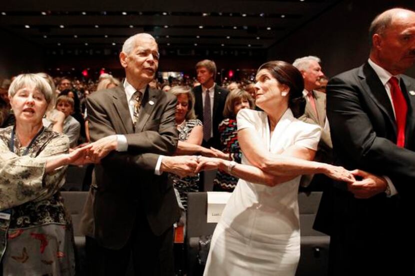 
Social activist Julian Bond and Luci Baines Johnson join in as the crowd sings “We Shall...