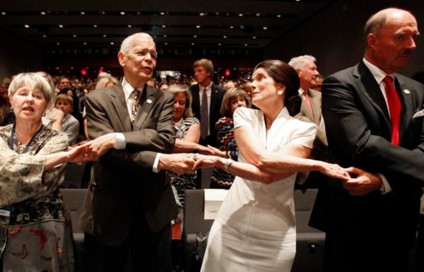 
Social activist Julian Bond and Luci Baines Johnson join in as the crowd sings “We Shall...