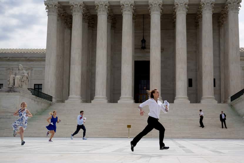  Interns run the Obamacare tax subsidies opinion to colleagues after the U.S. Supreme Court...