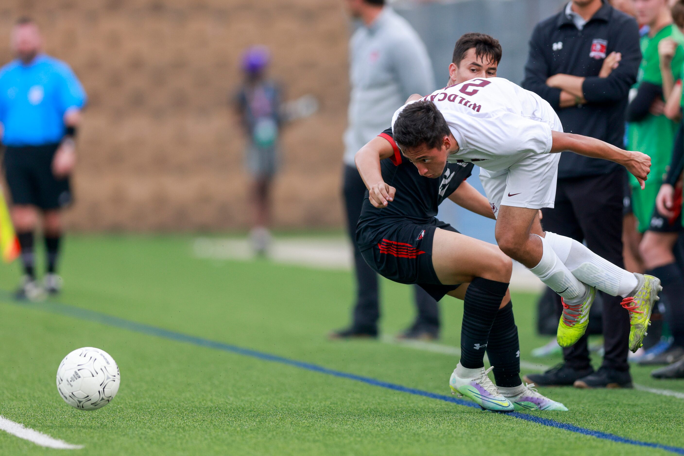 Austin Lake Travis forward Manuel Paez (20) tackles Plano midfielder Cristian Cifuentes (24)...