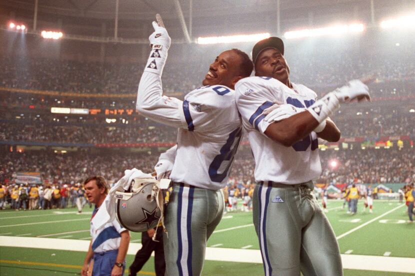Dallas Cowboys Alvin  Harper (L) and Michael Irvin climbed on the Buffalo Bill's bench after...