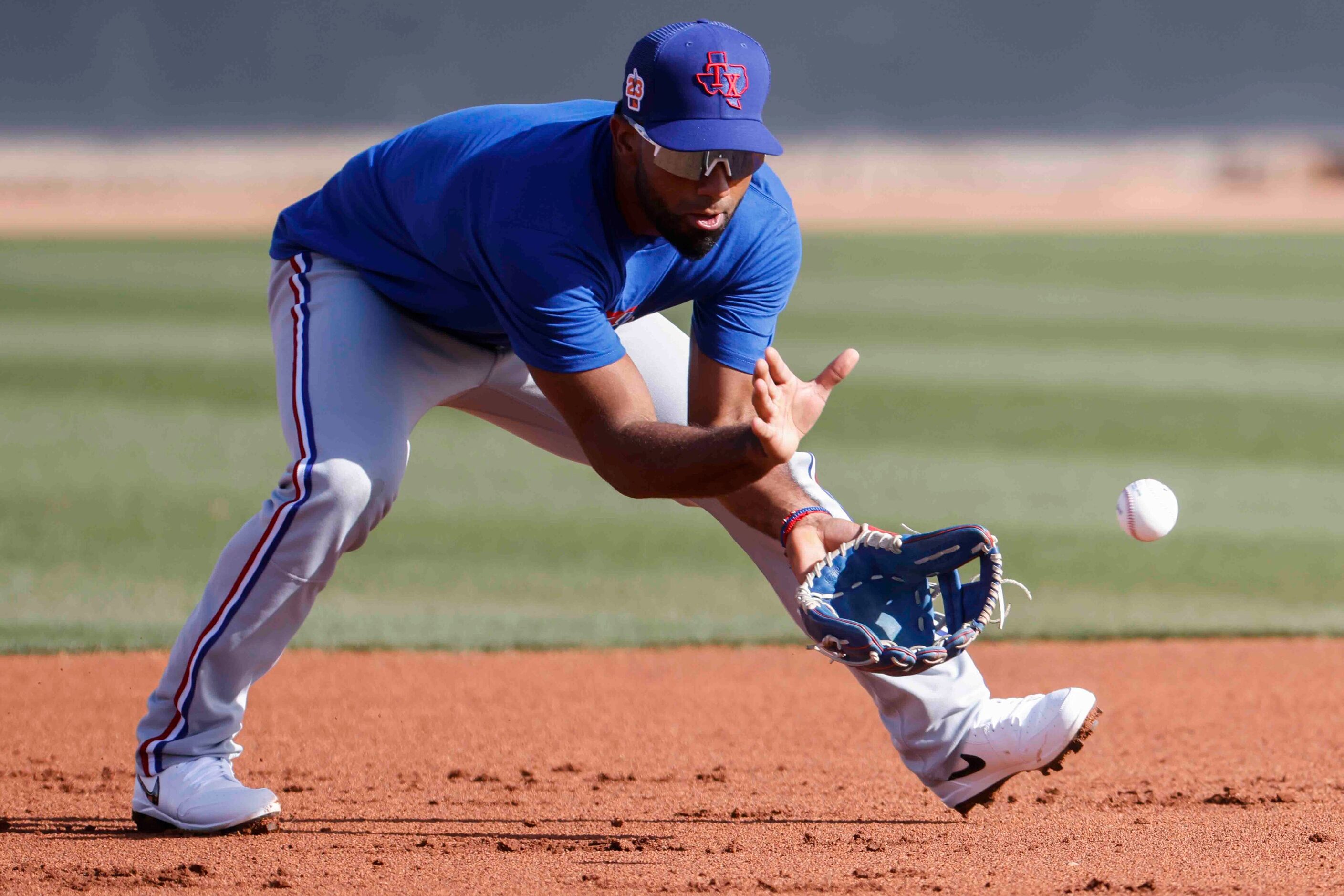 Texas Rangers infielder Ezequiel Duran takes part in fielding drill during a spring training...